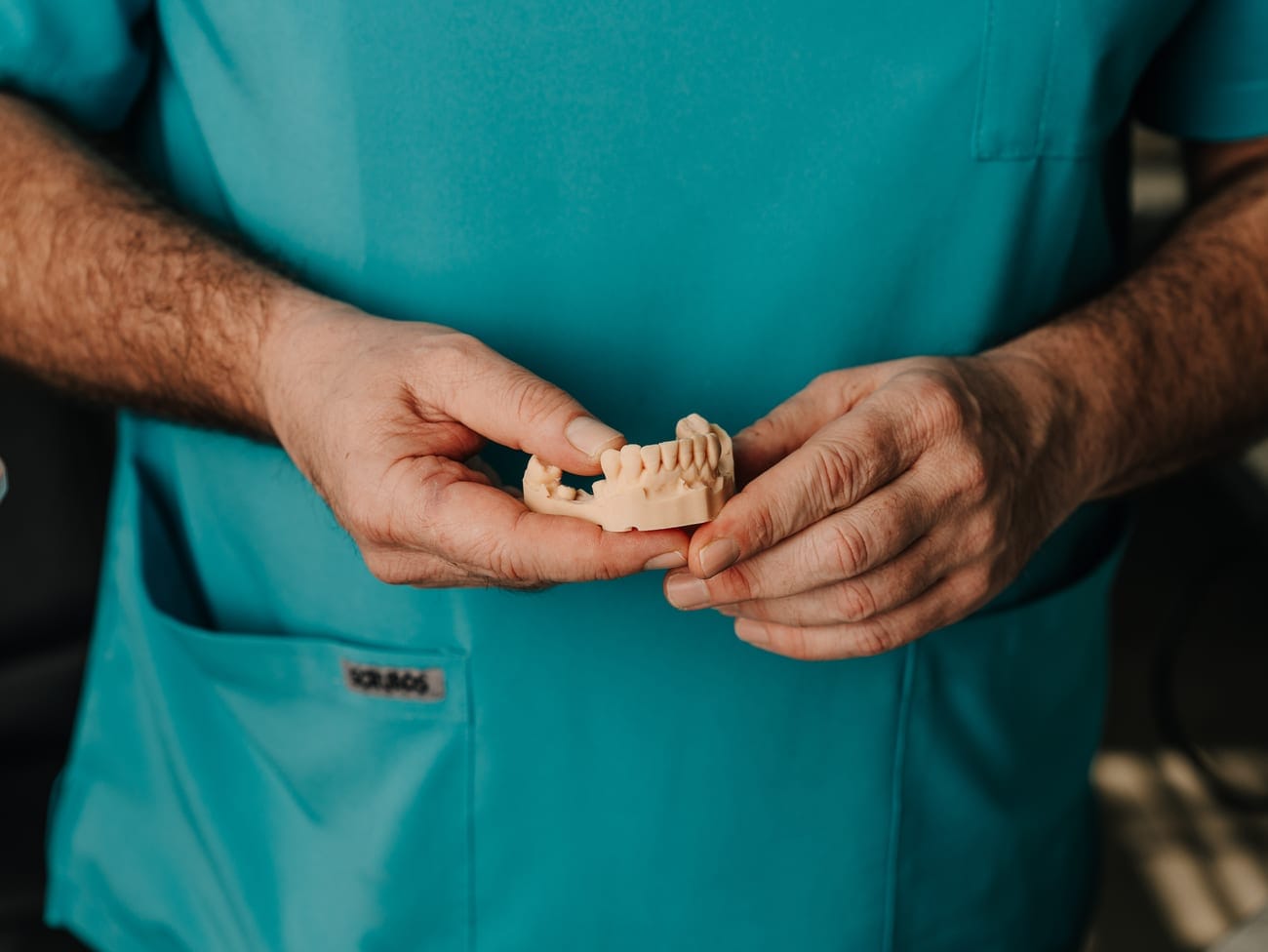 A Smile Connection dentist holding a dental study model at the practice in Newlands, Pretoria